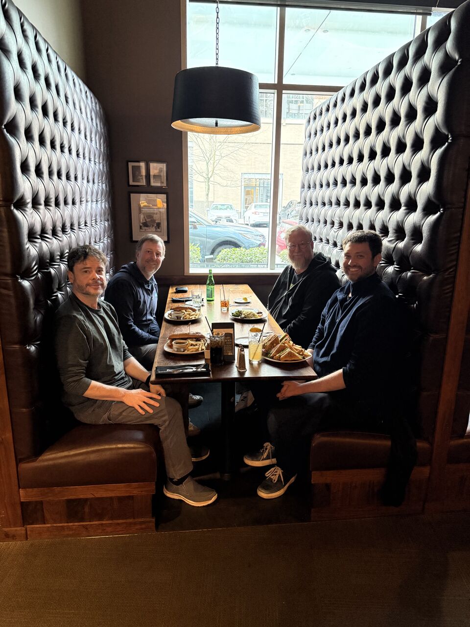 Steve Yegge and the Gas City crew gathered around a restaurant booth