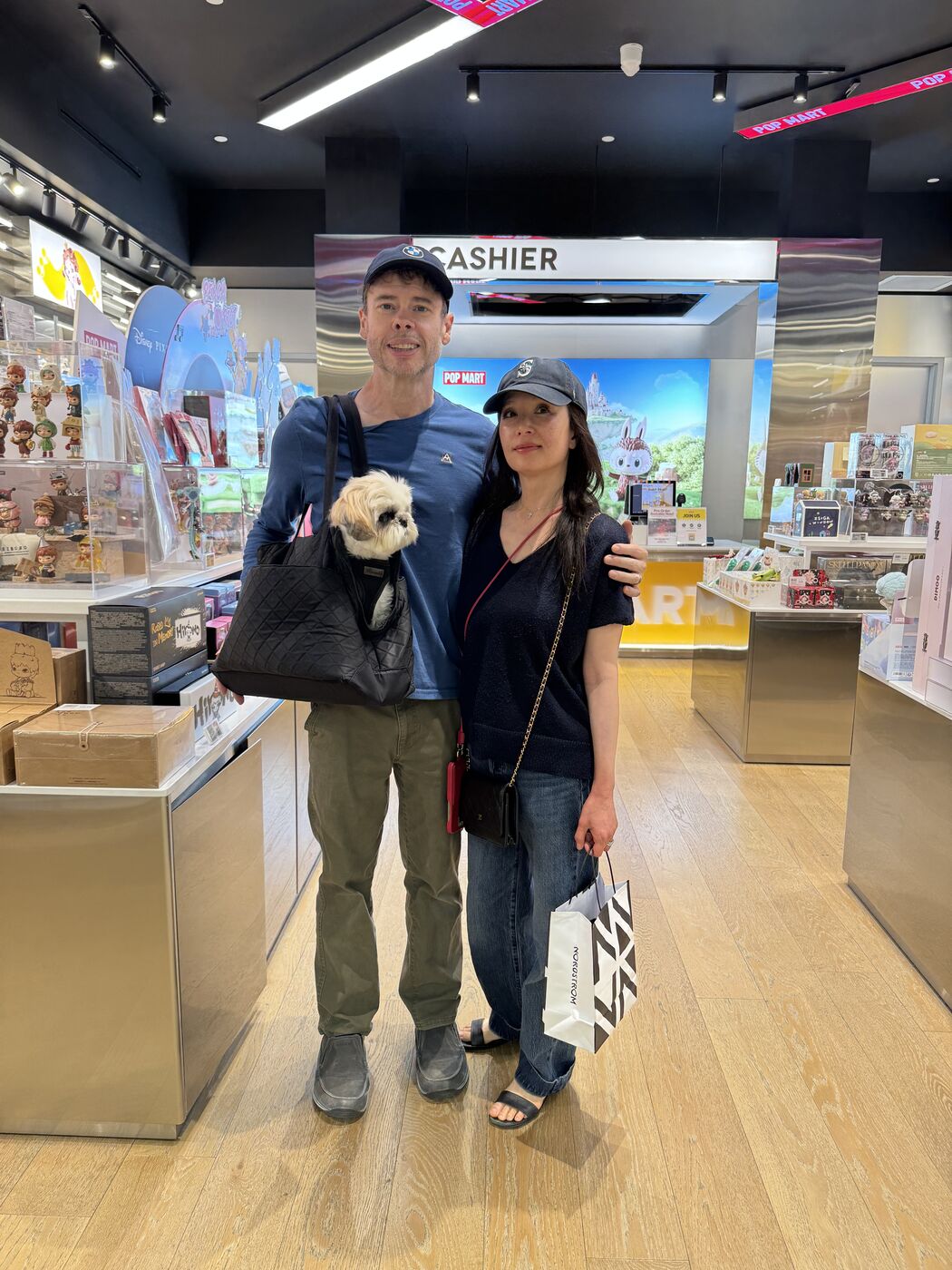 Steve and Linh with the dog at a Pop Mart store
