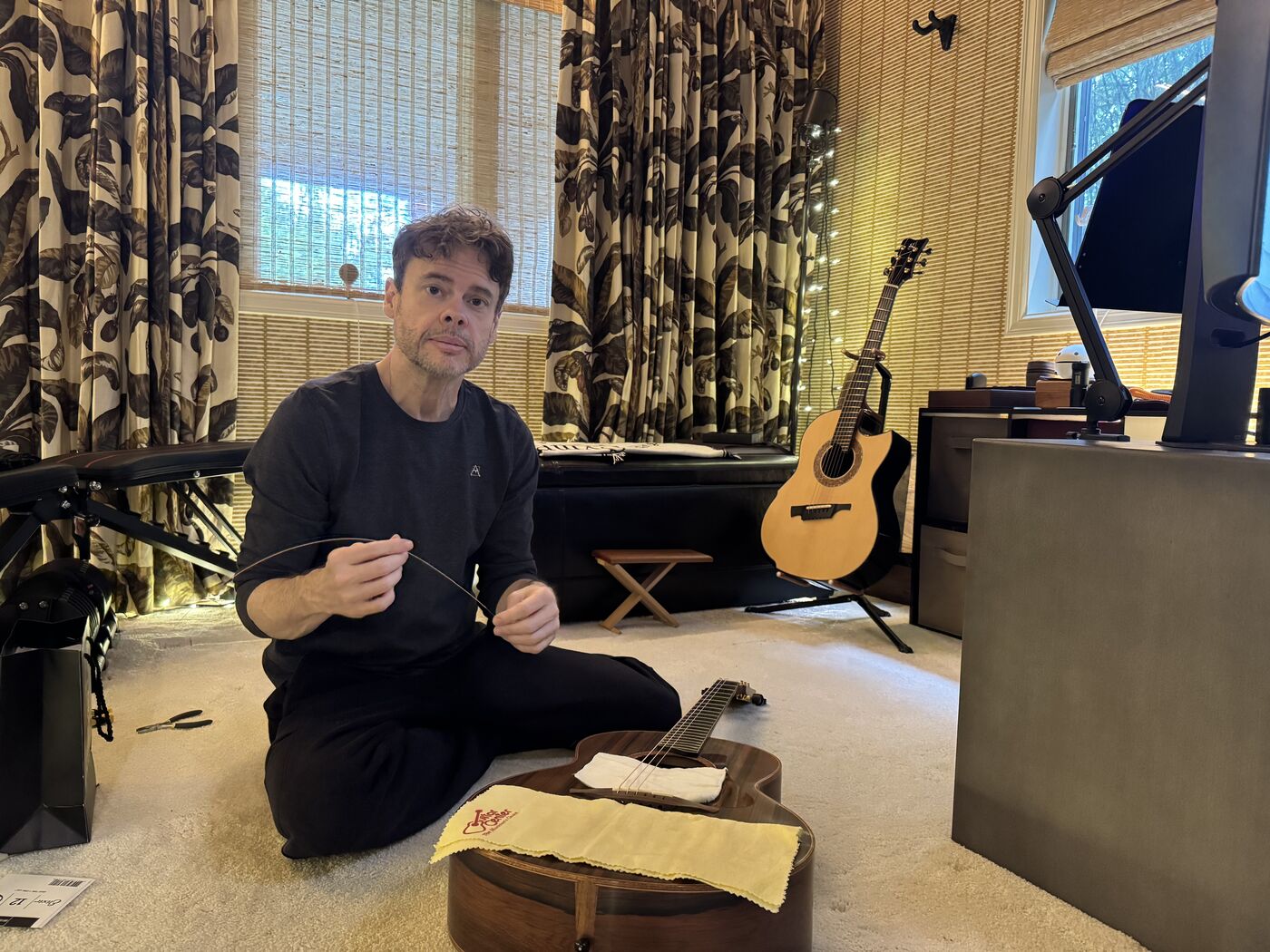 Steve restringing a guitar in the studio